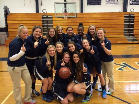 Girls Varsity Basketball team with their new coach on the far right.