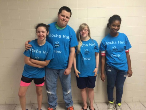 The Mocha Hut crew wear matching t shirts while delivering coffee.