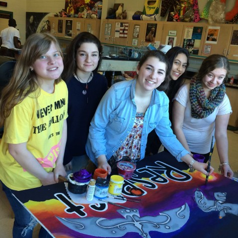 National Art Honor Society posed with one of their murals.