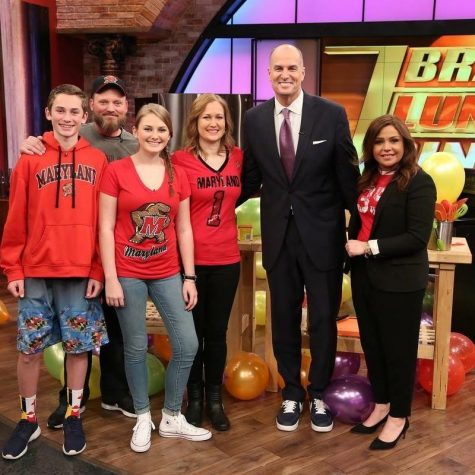 The Harper family poses with Rachael Ray and Jay Bilas after finishing the March Madness cook-off