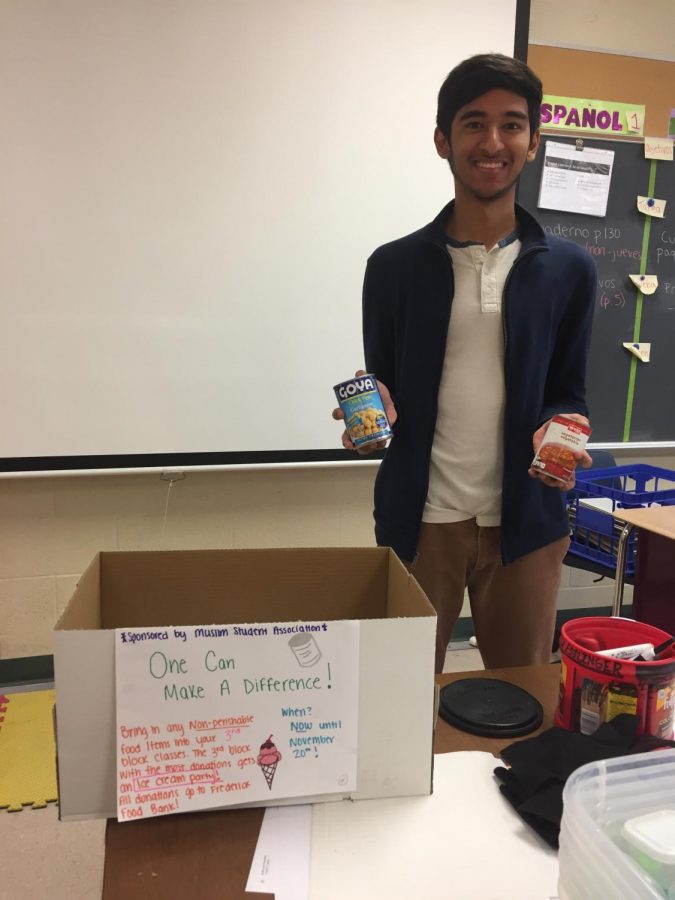 Rafay+Khan%2C+co-president+of+the+Muslim+Student+Association%2C+poses+with+some+cans+in+front+of+one+of+the+collection+boxes.