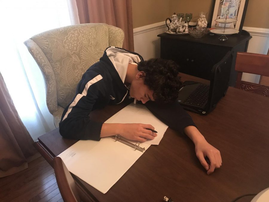 Photo illustration of freshman, Gavin Allanach, sleeping while doing homework.