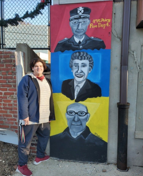 Tobias Weichbrod (11) stands beside his completed mural at Mt. Airys Simpson-Baker-Bowlus pop-up park.