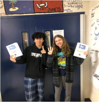 Left to Right: Lukas Gutierrez (11) and Nick Gerace (12), both playing Evan Goldman in UHS Drama’s production of 13, pose for a picture together with their scripts.