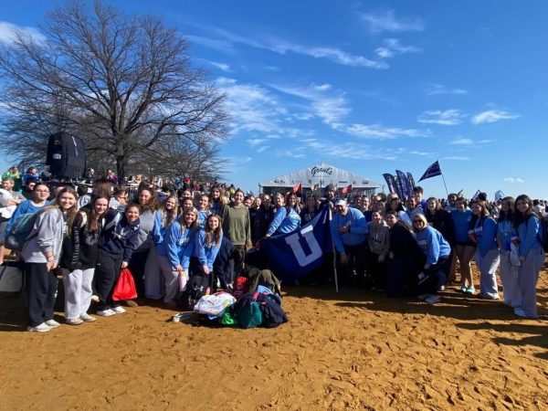 UHS staff and students gather on the beach to take a picture moments before running into the water (Photo by Unknown)
