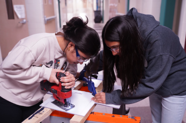 Deethya Bomma and Aditi Senthikumar working together to make the drivetrain electrical panel