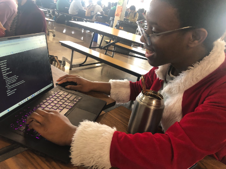 Ademide Akinsola (9) working on his To Do List for his upcoming show during lunch. He is dressed as Santa for GSA’s Character Day.
