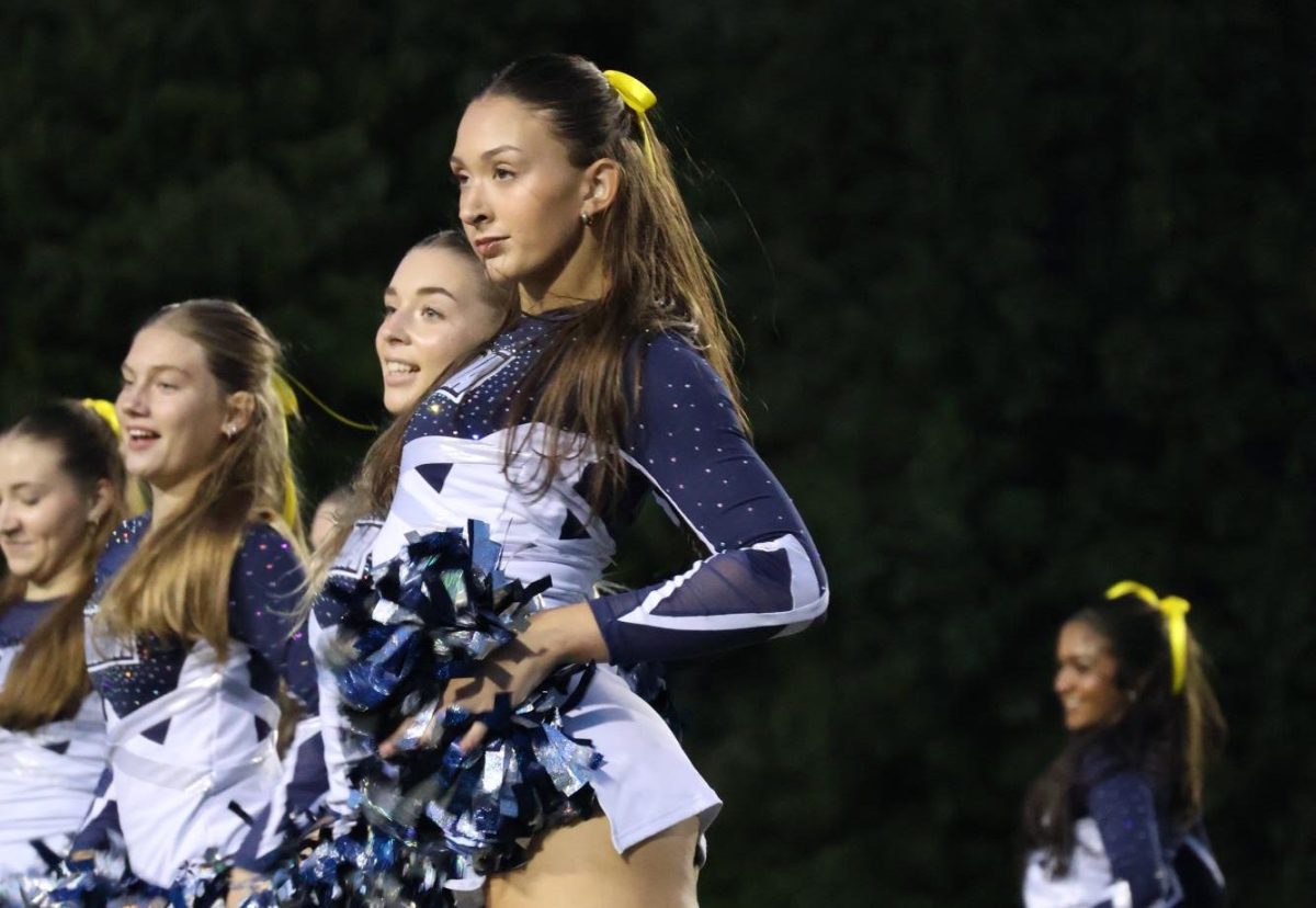 Annabell Clark, Reagan Davis, Ava Knapp, and Maddy Carliss take the field during halftime performance.