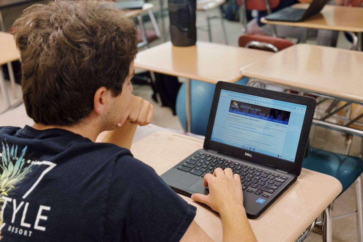 Senior William Knepper logs onto Maryland State Board of Elections in order to register.