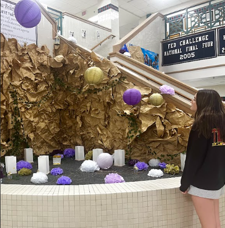 Junior Campbell Fedders viewing homecoming decorations located at the main stairwell. 