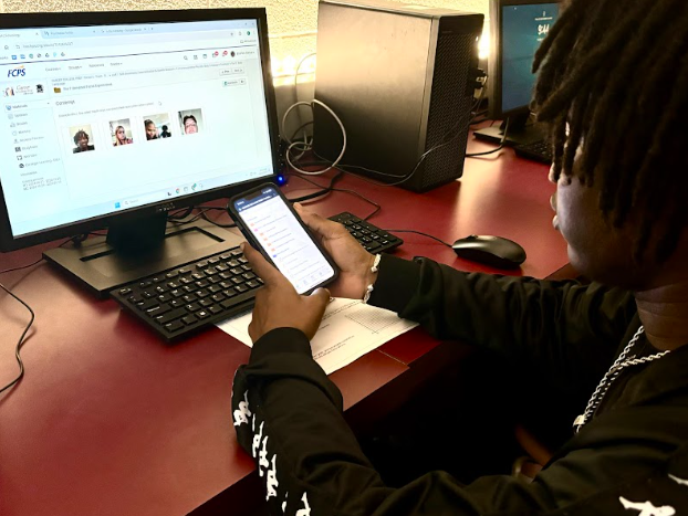 Ebrahim Ceesay (12) uses his phone to complete his assignment in Mr. Frush's career prep class.