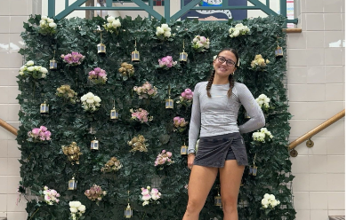 Quincy poses next to the 2024 Homecoming decorations.