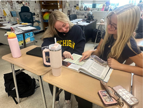 Seniors Brynn McPeak and Brooke Lieberman study their AP Human Geo textbook to prepare for a quiz retake.