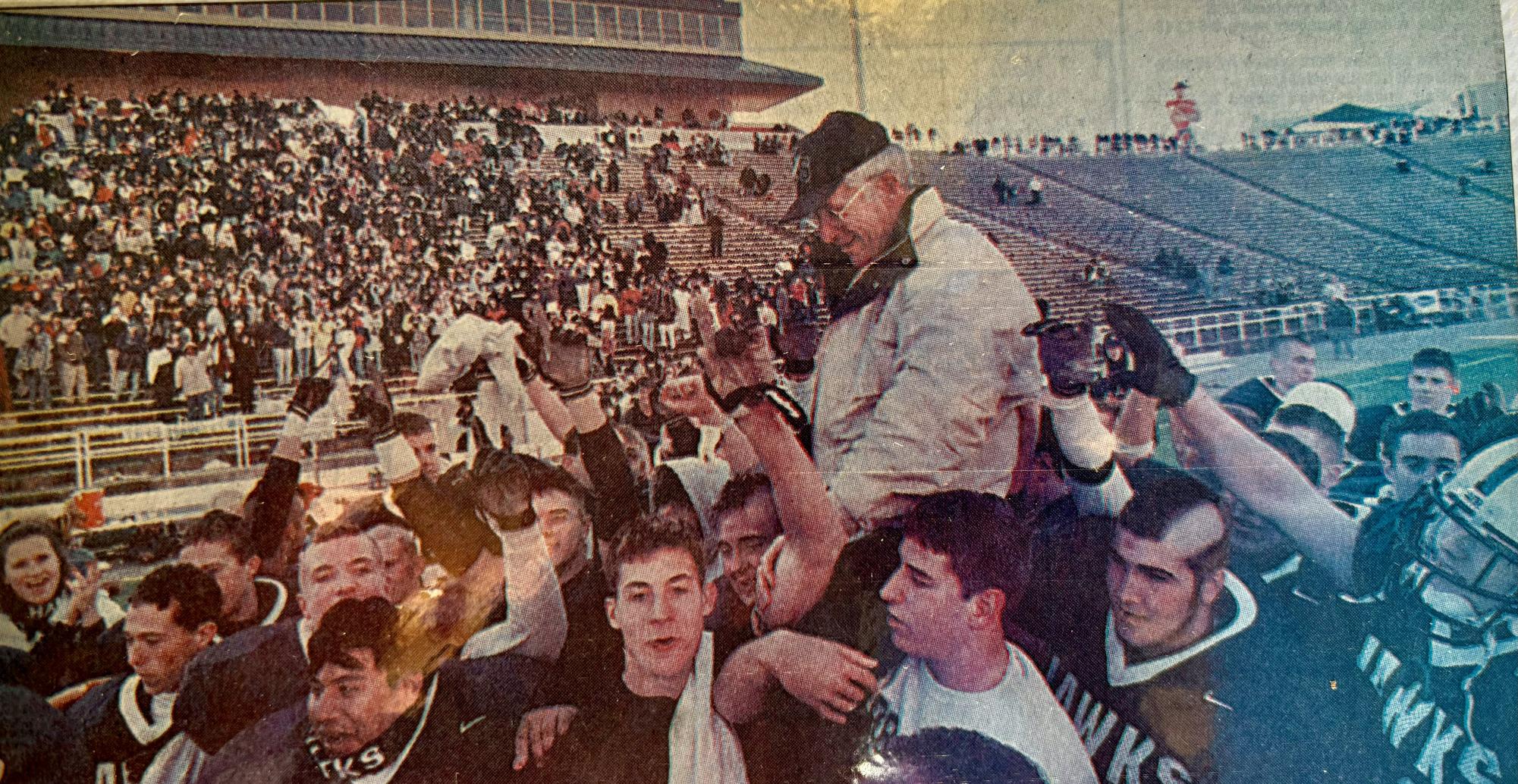 Coach Carruthers gets carried on the shoulders of the 2001 Urbana football team after winning their fourth straight state championship.