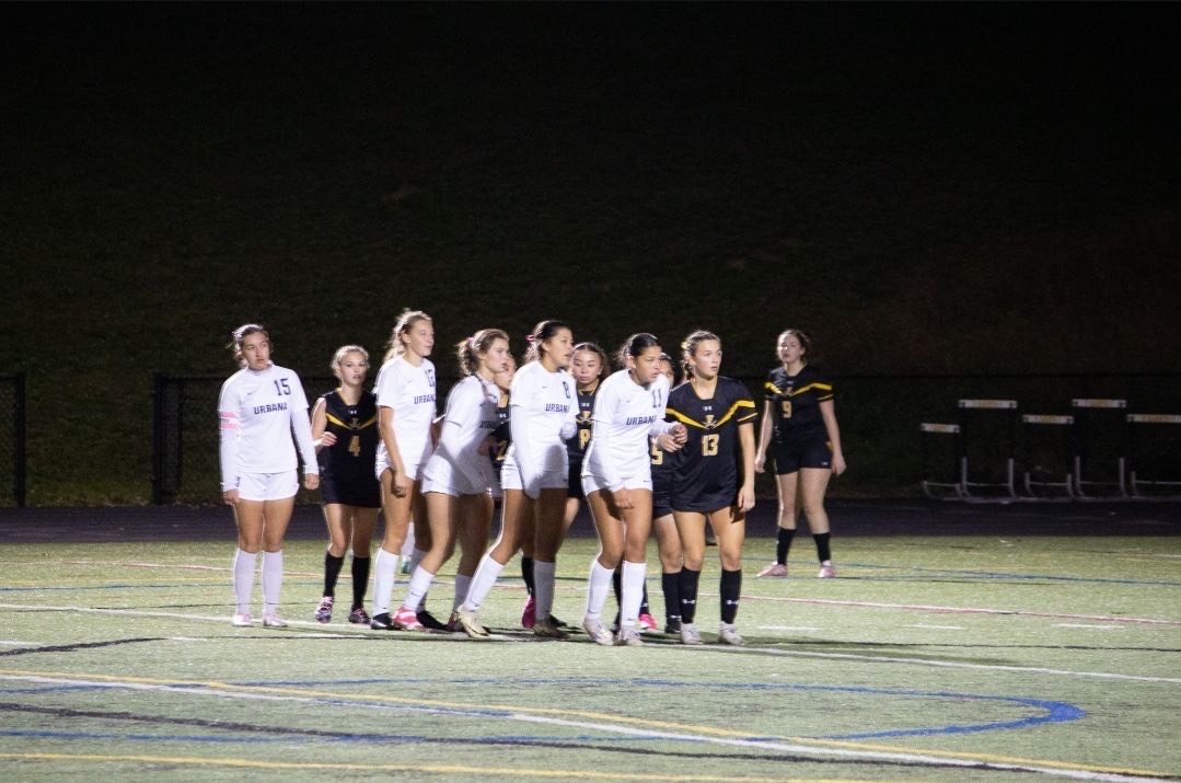 Urbana players (from left): Logan Vu (15), Mia Schwarz (12), Reese Bender (21), Arielle Raborg (8), and Graycee Raborg (11) prepare to receive a corner kick during their 5-1 win against Frederick High School.