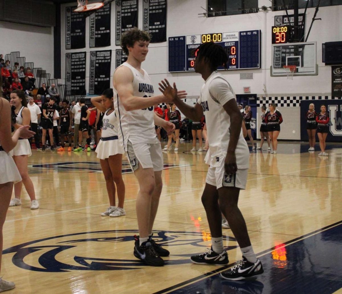 Senior Mason Johnson daps up teammate Moses Adoko.
(Mason Johnson,Moses Adoko)