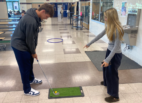 Bella Charoenying instructs Vince Corso on the best way to hit a hole-in-one!