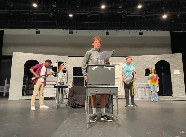 Christopher Doyle-Wandell recites a speech for the play in front of Ademide Akinsola, Jennifer Baxter, Christopher Brookes, and Nikki Hasenbuhler.