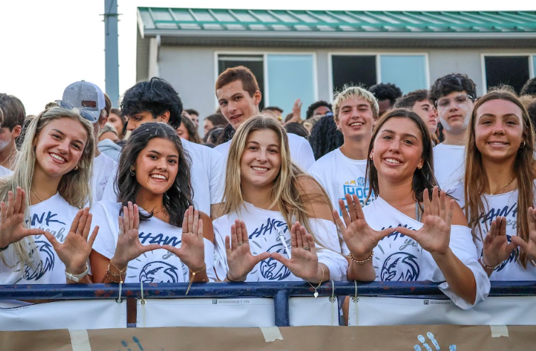 The Hawkettes (Alexa Roberton, Hannah Milor, Mayson Smith, Mia Hostler, Helaina Cullum) smile and represent the "U" at the first football game! 