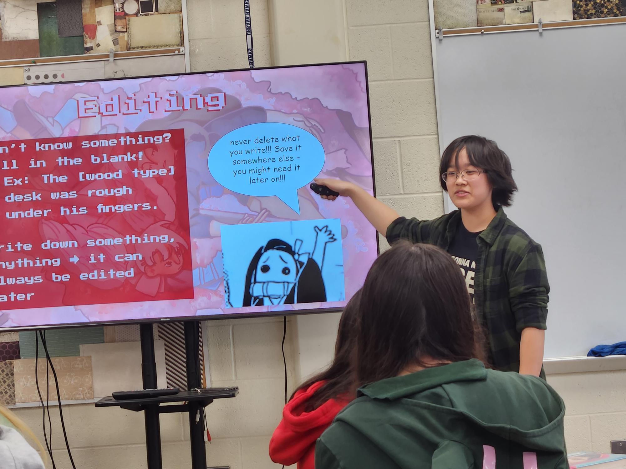 Lillian Sun explains the basics of editing stories to the members of the Young Writer's Workshop club.