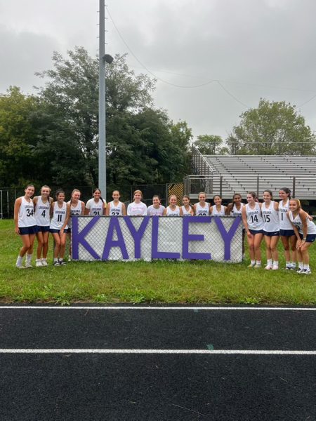 UHS Varsity Field Hockey team celebrates their win of the purple-out game with a banner to honor Kayley Milor.