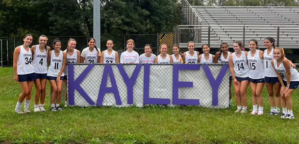 UHS Varsity Field Hockey team celebrates their win of the purple-out game with a banner to honor Kayley Milor.