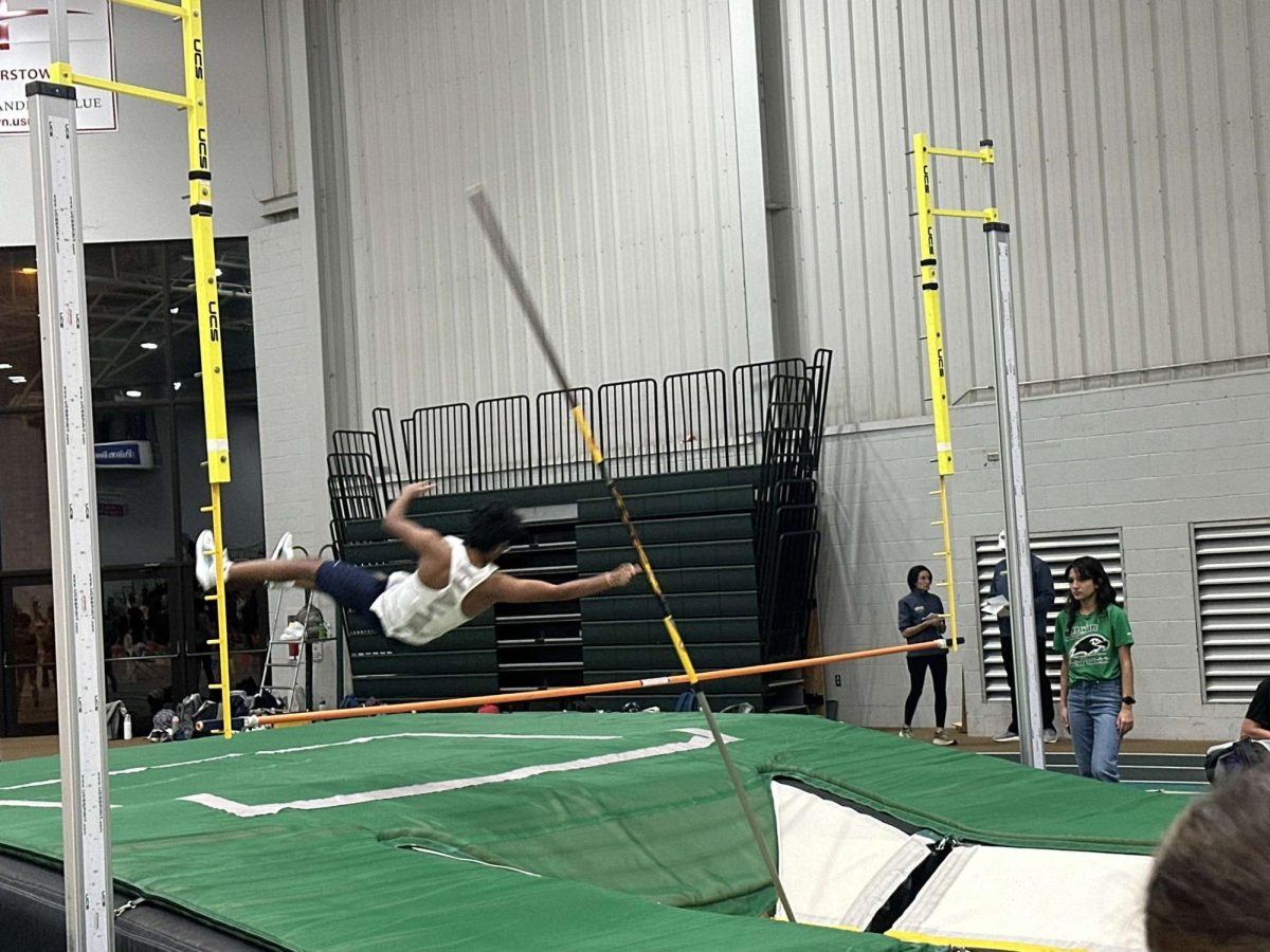 Nathan Abeysiriwardana, Class of 2027, in action as he pole vaults successfully.