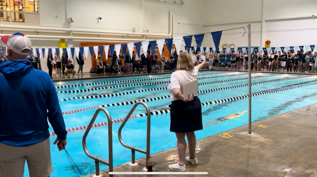 Middletown pool is surrounded by both teams cheering on their swimmers!