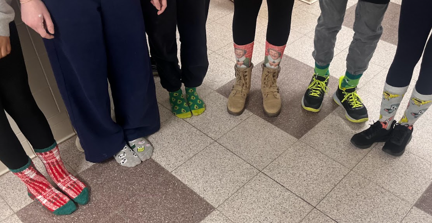 Left to right - Tristen Manners, Emmy Gardiner, Aurora Kling, Harlikleia Robinson, Isaac Reyes, and Chongzeng Ma show off their silly socks!