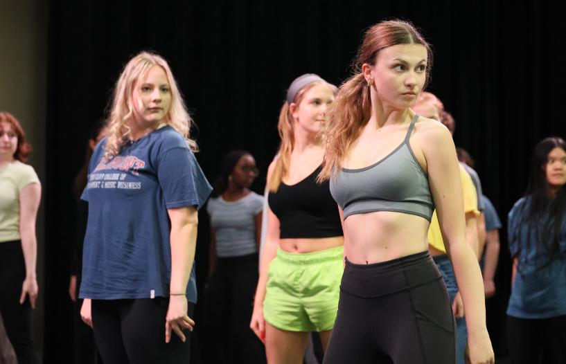 Students practicing on stage the choreography for the song "Skid Row" from Little Shop of Horrors. Students from left to right: Piper Estok, Jennifer Baxter, Emma Gadbois.