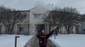 Lucas Montero (Class of 2025) shows his love for snow days in front of the school, spreading the snow through the air.