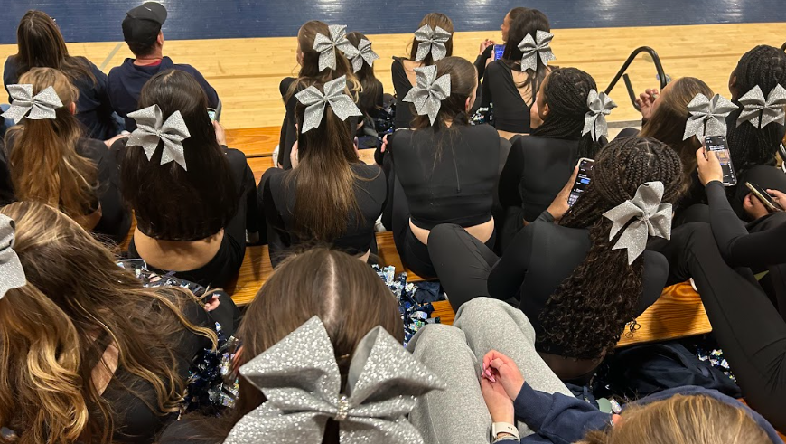 Urbana Pom Club and their sparkly bows take a rest on the bleachers after an incredible and tiring routine.