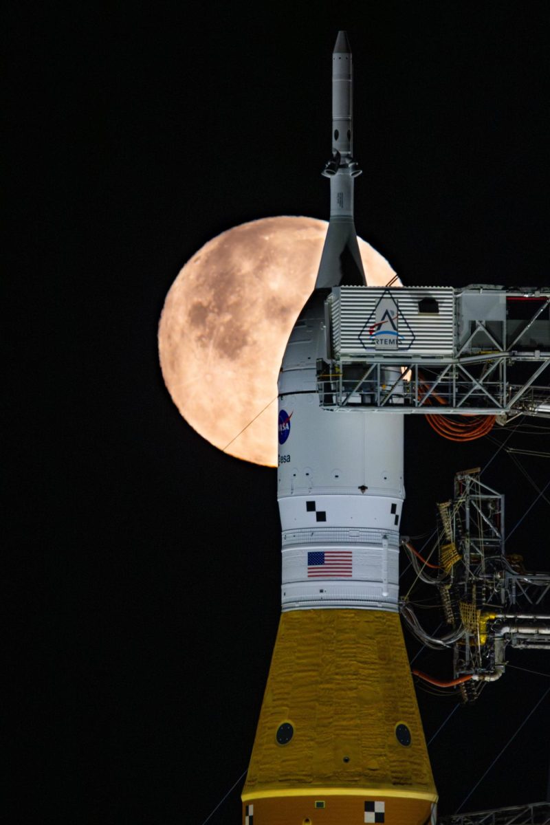 The Orion spacecraft awaits blastoff with the moon in the background. Photograph by Sam Lott via NASA. 