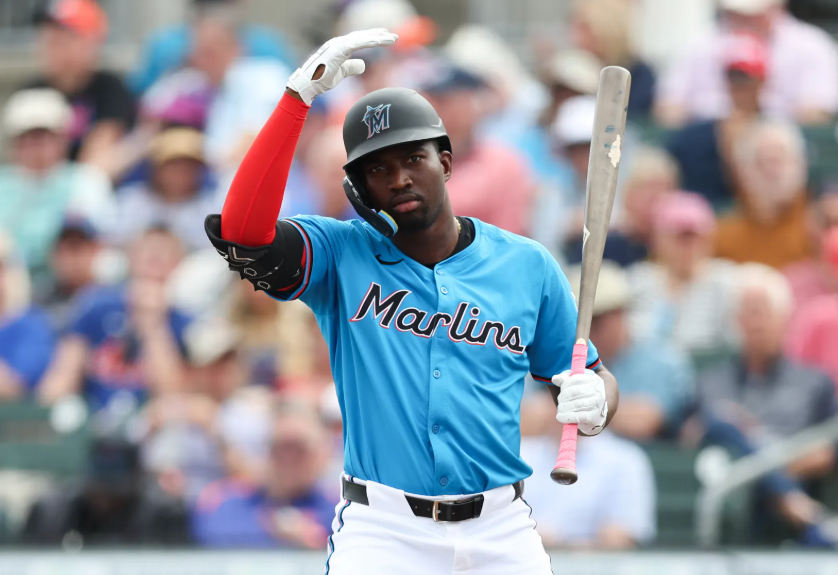 Marlins outfielder Jesús Sánchez taps his head to initiate an ABS challenge during a spring training game in 2026.