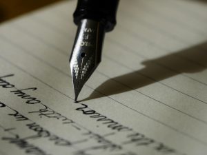 Writing with a fountain pen via Unsplash