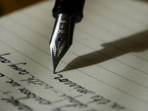Writing with a fountain pen via Unsplash